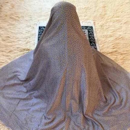 A woman using a lightweight, without sleeves namaz chadar design during Salah.