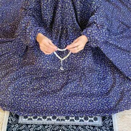 A woman wearing a printed full-length namaz chadar with Sleeves, showcasing its loose, flowy fit and long sleeves for complete coverage during Namaz. Clothifydotpk