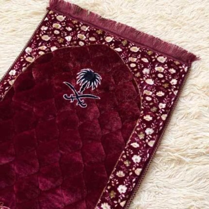 A beautifully patterned quilted padded prayer mat laid out flat By Clothifydotpk