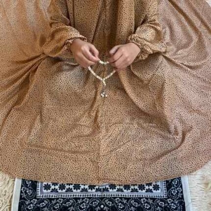 a kid with namaz scarf with sleeves offering salah. By Clothifydotpk