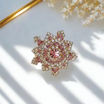 Close-up photo of a brooch with rhinestones.