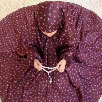 A young girl wearing kids namaz chadar with sleeves, offering salah from Clothifydotpk