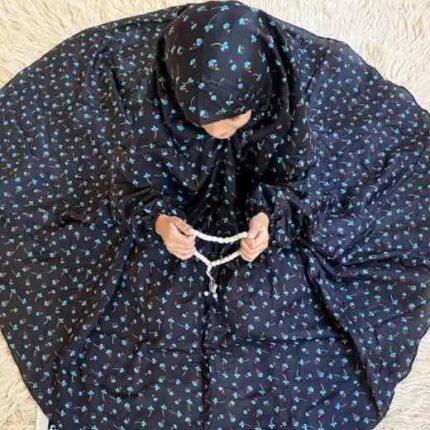 A young girl wearing kids namaz chadar with sleeves, offering salah from Clothifydotpk