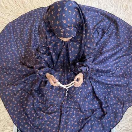 A young girl wearing kids namaz chadar with sleeves, offering salah from Clothifydotpk