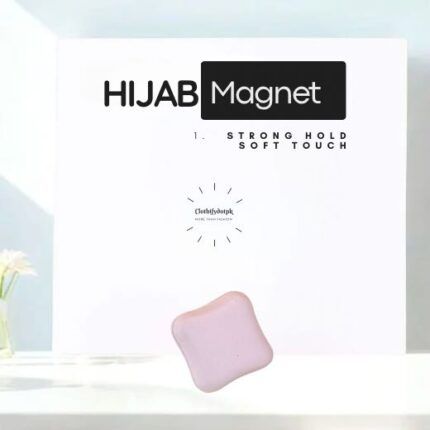 A pair of small, matte hijab magnets for securing a scarf.
