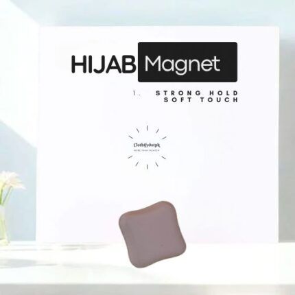 A pair of small, matte hijab magnets for securing a scarf.