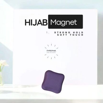 A pair of small, matte hijab magnets for securing a scarf.