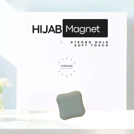 A pair of small, matte hijab magnets for securing a scarf.