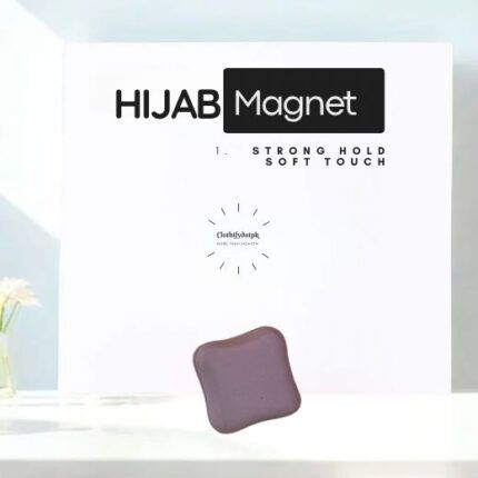 A pair of small, matte hijab magnets for securing a scarf.