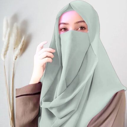 A woman wearing a Misri hijab draped over the head and shoulders with attached Niqab