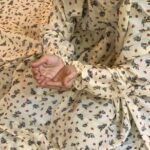 A woman using a breathable soft swiss lawn Namaz Chadar with Sleeves and pocket, performing salah By Clothifydotpk