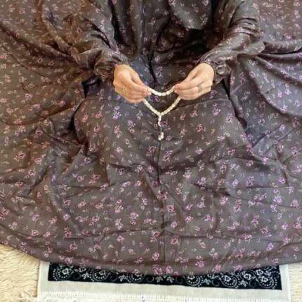A woman using a breathable soft swiss lawn Namaz Chadar with Sleeves and pocket, performing salah By Clothifydotpk