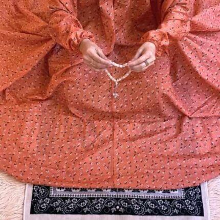 A woman using a breathable soft swiss lawn Namaz Chadar with pocket, performing salah By Clothifydotpk