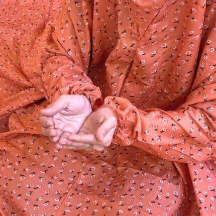 A woman using a breathable soft swiss lawn Namaz Chadar with pocket, performing salah By Clothifydotpk