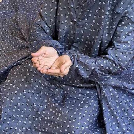 A woman using a breathable soft swiss lawn Namaz Chadar with pocket, performing salah By Clothifydotpk