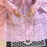 A woman using a breathable soft swiss lawn Namaz Chadar with sleeves, performing salah By Clothifydotpk