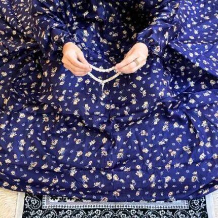 A woman using a breathable soft swiss lawn Namaz Chaddar with Sleeves, performing salah By Clothifydotpk