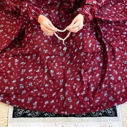 A woman using a breathable soft swiss lawn Namaz Chadar with pocket, performing salah By Clothifydotpk