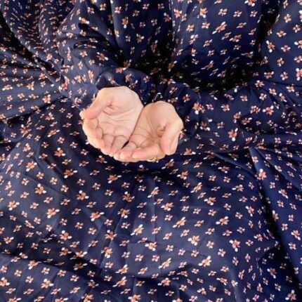 A woman wearing a printed full-length namaz chadar with pocket, showcasing its loose, flowy fit and long sleeves for complete coverage during Namaz. Clothifydotpk