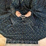 A woman wearing a printed full-length namaz chadar with pocket, showcasing its loose, flowy fit and long sleeves for complete coverage during Namaz. Clothifydotpk