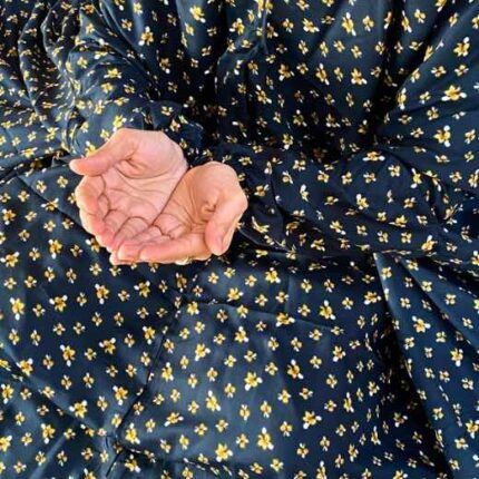 A woman wearing a printed full-length namaz chadar with pocket, showcasing its loose, flowy fit and long sleeves for complete coverage during Namaz. Clothifydotpk