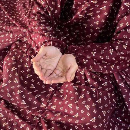 A woman using a breathable soft swiss lawn Namaz Chadar, performing salah By Clothifydotpk