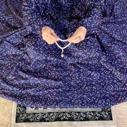 A woman wearing a printed full-length namaz chadar with pocket, showcasing its loose, flowy fit and long sleeves for complete coverage during Namaz. Clothifydotpk