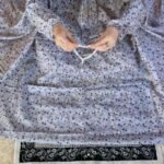 A woman wearing a printed full-length namaz chadar with pocket, showcasing its loose, flowy fit and long sleeves for complete coverage during Namaz. Clothifydotpk