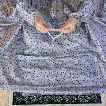 A woman wearing a printed full-length namaz chadar with pocket, showcasing its loose, flowy fit and long sleeves for complete coverage during Namaz. Clothifydotpk