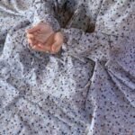 A woman wearing a printed full-length namaz chadar with pocket, showcasing its loose, flowy fit and long sleeves for complete coverage during Namaz. Clothifydotpk