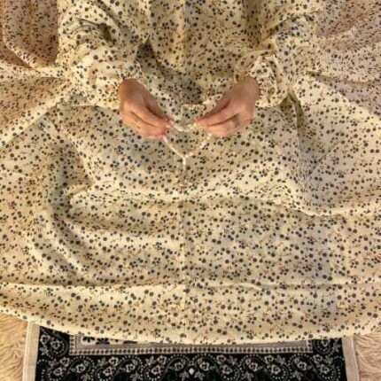 A woman wearing a printed full-length namaz chadar with pocket, showcasing its loose, flowy fit and long sleeves for complete coverage during Namaz. Clothifydotpk