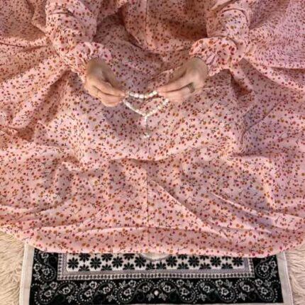 A woman wearing a printed full-length namaz chadar with pocket, showcasing its loose, flowy fit and long sleeves for complete coverage during Namaz. Clothifydotpk