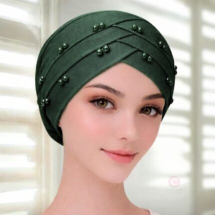 A woman wearing a tie-back fancy 3 layer pearl hijab cap with delicate pearls, visible under a sheer or light hijab.
