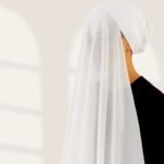 A woman wearing a ready-to-wear instant chiffon hijab, featuring a soft, flowy drape and pre-stitched design for easy wear with inner under cap. By Clothifydotpk
