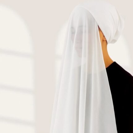 A woman wearing a ready-to-wear instant chiffon hijab, featuring a soft, flowy drape and pre-stitched design for easy wear with inner under cap. By Clothifydotpk