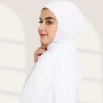 A woman wearing a ready-to-wear instant chiffon hijab, featuring a soft, flowy drape and pre-stitched design for easy wear with inner under cap. By Clothifydotpk