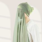 A woman wearing a ready-to-wear instant chiffon hijab, featuring a soft, flowy drape and pre-stitched design for easy wear with inner under cap. By Clothifydotpk