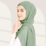 A woman wearing a ready-to-wear instant chiffon hijab, featuring a soft, flowy drape and pre-stitched design for easy wear with inner under cap. By Clothifydotpk