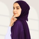A woman wearing a violet color ready-to-wear instant chiffon hijab, featuring a soft, flowy drape and pre-stitched design for easy wear with inner under cap. By Clothifydotpk