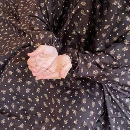 A woman using a breathable soft swiss lawn Namaz Chadar with Sleeves, performing salah By Clothifydotpk