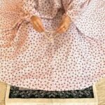 A woman using a breathable soft swiss lawn Namaz Chadar with Sleeves, performing salah By Clothifydotpk