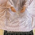 A woman using a breathable soft swiss lawn Namaz Chadar with Sleeves, performing salah By Clothifydotpk