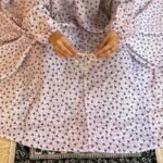 A woman using a breathable soft swiss lawn Namaz Chadar with Sleeves, performing salah By Clothifydotpk