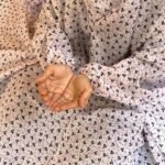 A woman using a breathable soft swiss lawn Namaz Chadar with Sleeves, performing salah By Clothifydotpk