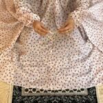 A woman using a breathable soft swiss lawn Namaz Chadar with Sleeves, performing salah By Clothifydotpk
