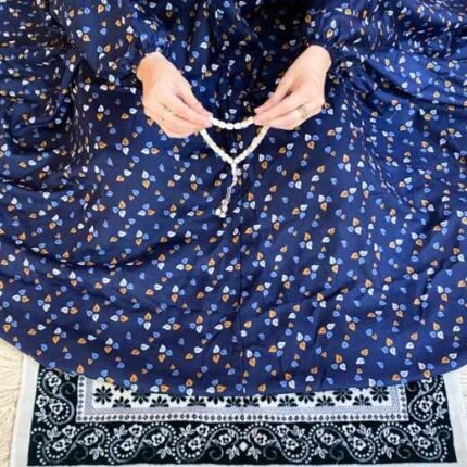 A woman using a breathable soft swiss lawn Printed Namaz Chadar with Sleeves, performing salah By Clothifydotpk