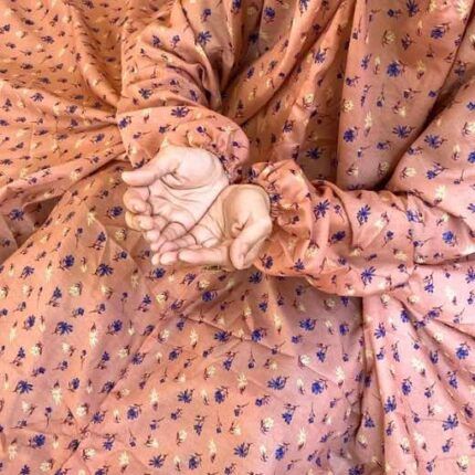 A woman using a breathable soft swiss lawn Printed Namaz Chadar with sleeves, performing salah By Clothifydotpk