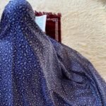 A woman weraring namaz chadar without sleeves also known as Makhna Hijab or Namaz Makhna.