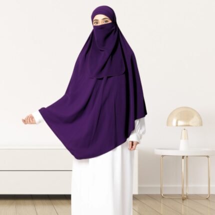 A woman wearing a long, single layer khimar that drapes over the head, and shoulders, falling to about waist length.