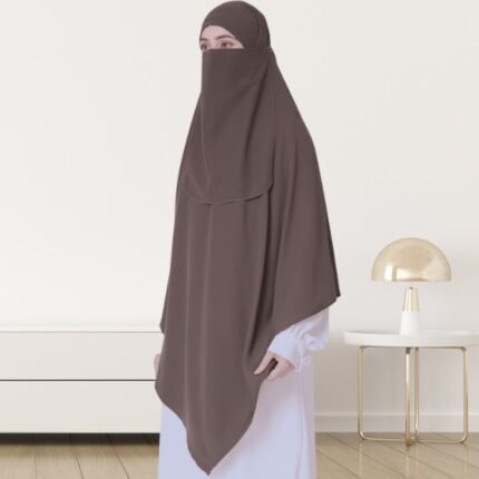 A woman wearing a long, single layer khimar that drapes over the head, and shoulders, falling to about waist length.